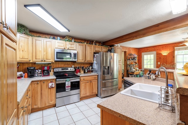 kitchen featuring sink, appliances with stainless steel finishes, and light tile floors