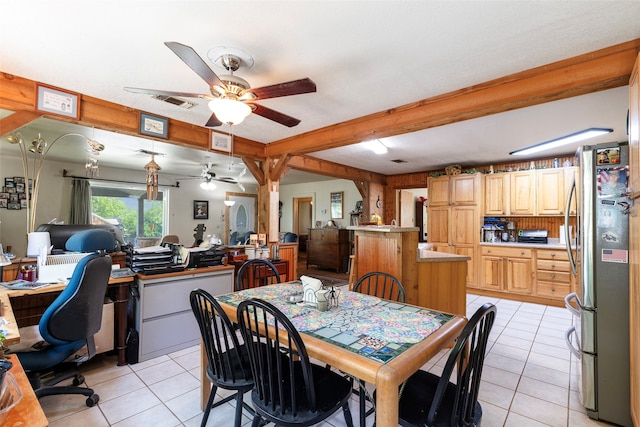 dining room featuring beam ceiling, ceiling fan, and light tile flooring