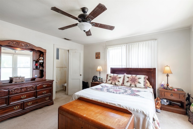 carpeted bedroom featuring ceiling fan and connected bathroom