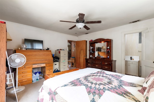 bedroom with connected bathroom, ceiling fan, and carpet