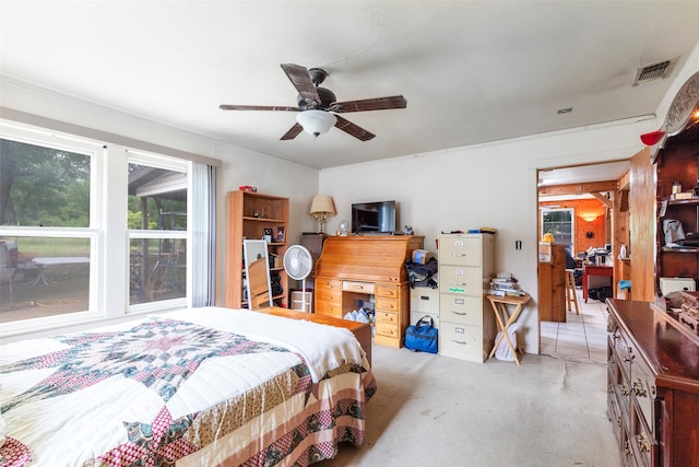 bedroom with light colored carpet and ceiling fan