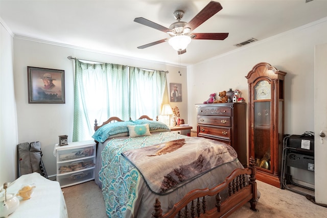 carpeted bedroom with ceiling fan and crown molding