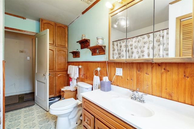 bathroom with wood walls, oversized vanity, tile floors, and toilet