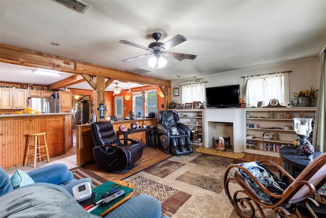 living room with beamed ceiling, ceiling fan, and light tile floors