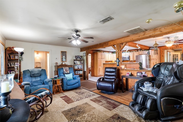 living room with beam ceiling and ceiling fan