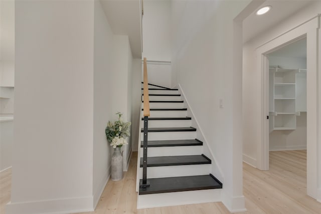 stairs featuring wood-type flooring