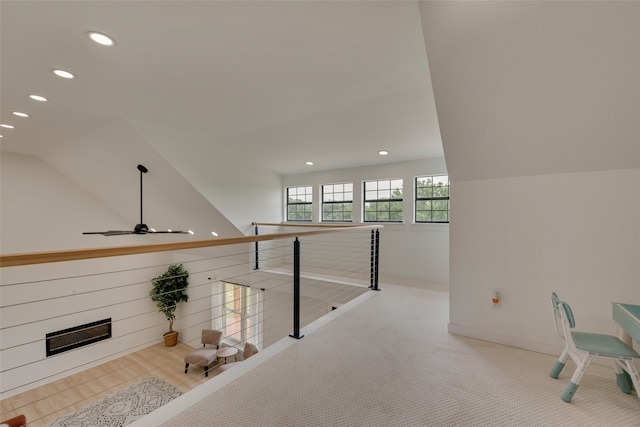 interior space with vaulted ceiling and light colored carpet