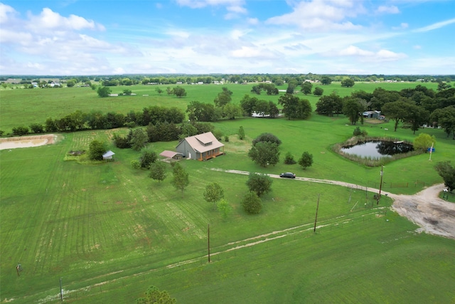 birds eye view of property with a rural view and a water view