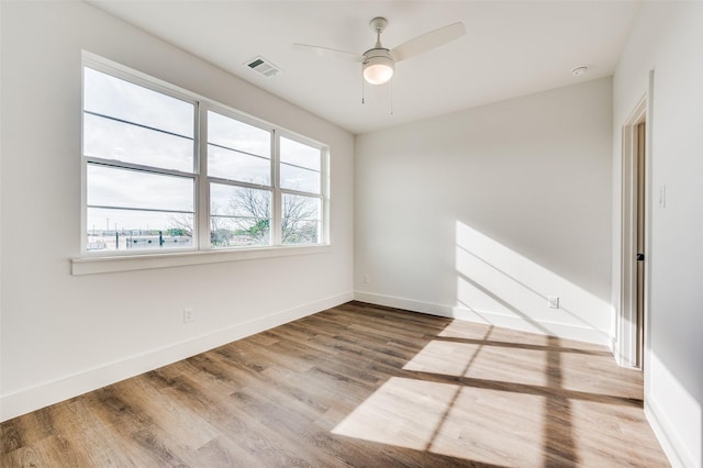 empty room featuring ceiling fan and wood-type flooring