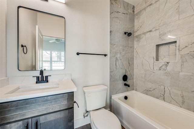 full bathroom featuring toilet, tiled shower / bath combo, and vanity