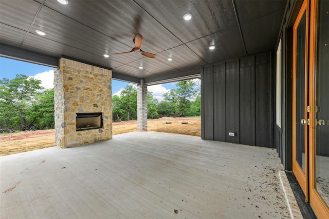 view of patio with ceiling fan and an outdoor stone fireplace