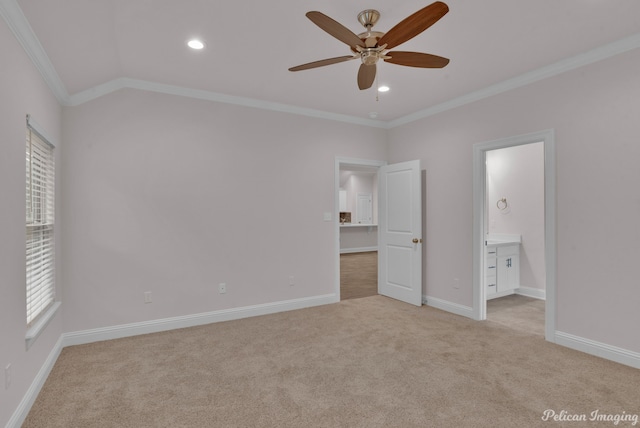 unfurnished bedroom with ceiling fan, light carpet, ensuite bath, crown molding, and vaulted ceiling