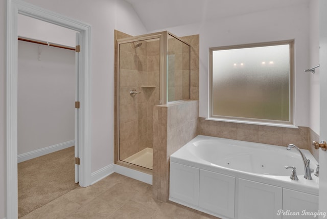 bathroom featuring tile flooring and shower with separate bathtub