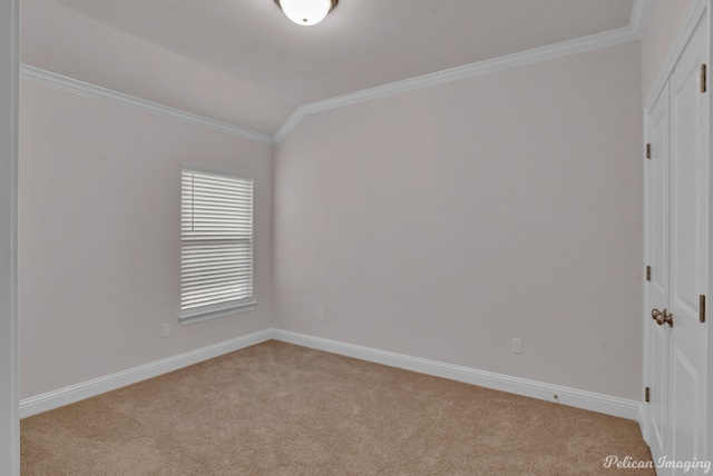 carpeted spare room with vaulted ceiling and crown molding