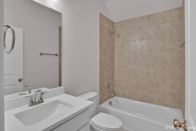 full bathroom featuring tiled shower / bath combo, vanity, and toilet