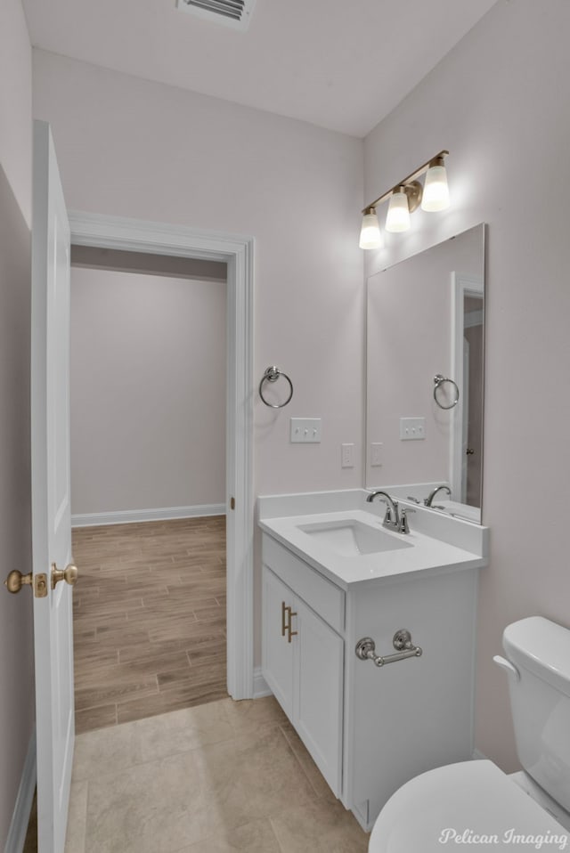 bathroom with large vanity, tile floors, and toilet