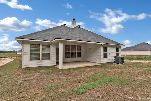 back of house with a patio area, central air condition unit, and a lawn