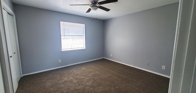 carpeted empty room featuring ceiling fan and a textured ceiling