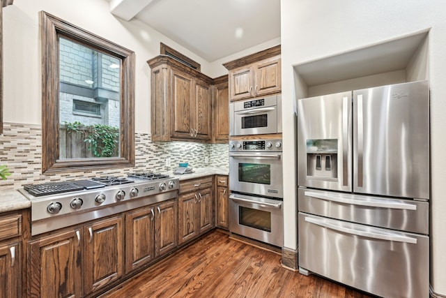 kitchen featuring decorative backsplash, dark hardwood / wood-style flooring, and appliances with stainless steel finishes