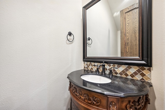 bathroom with vanity and tasteful backsplash