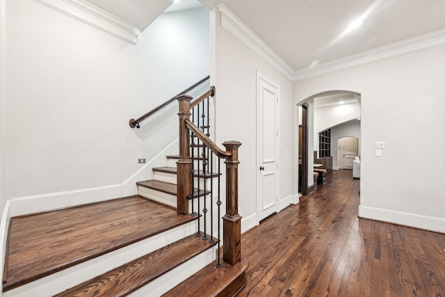 stairs featuring wood-type flooring and ornamental molding