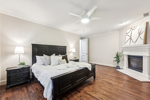 bedroom with dark hardwood / wood-style flooring, ceiling fan, and ornamental molding