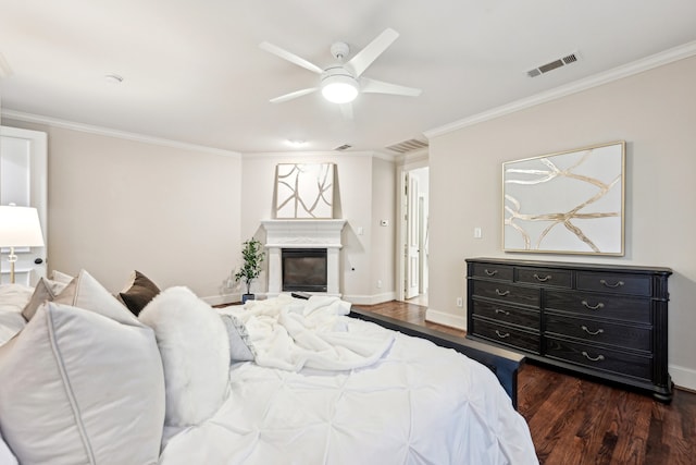 bedroom featuring ornamental molding, ceiling fan, and dark wood-type flooring