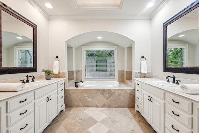 bathroom featuring vanity, tiled bath, and ornamental molding