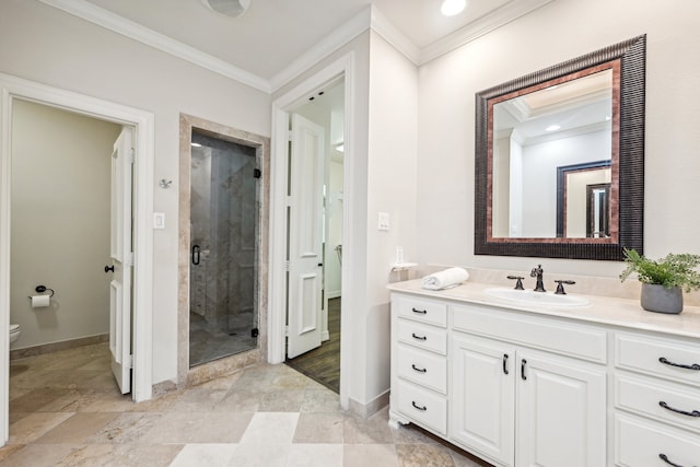 bathroom with ornamental molding, vanity, a shower with shower door, and toilet