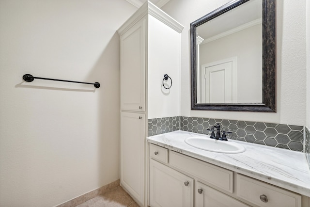 bathroom featuring vanity, backsplash, and crown molding