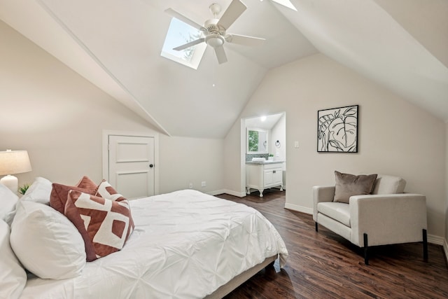 bedroom featuring ensuite bathroom, dark wood-type flooring, multiple windows, lofted ceiling with skylight, and ceiling fan