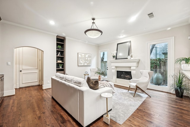 living room with dark hardwood / wood-style floors and crown molding