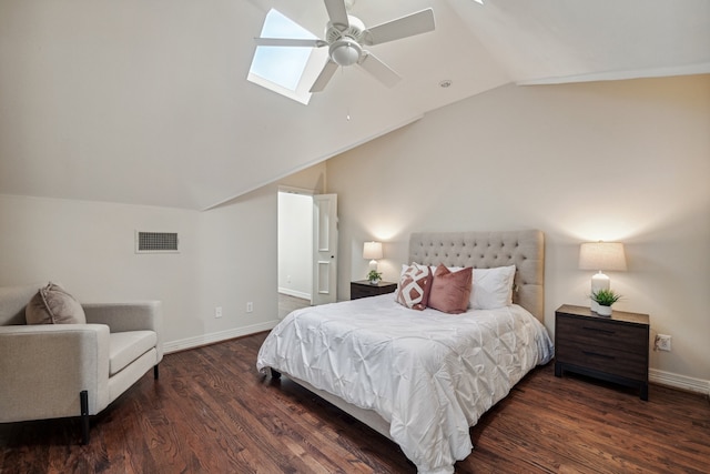 bedroom with vaulted ceiling with skylight, ceiling fan, and dark wood-type flooring