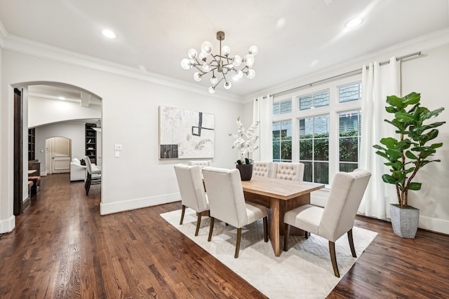 dining room featuring ornamental molding, a chandelier, and dark hardwood / wood-style flooring