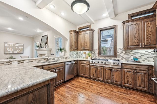 kitchen featuring decorative backsplash, stainless steel appliances, dark wood-type flooring, sink, and beamed ceiling