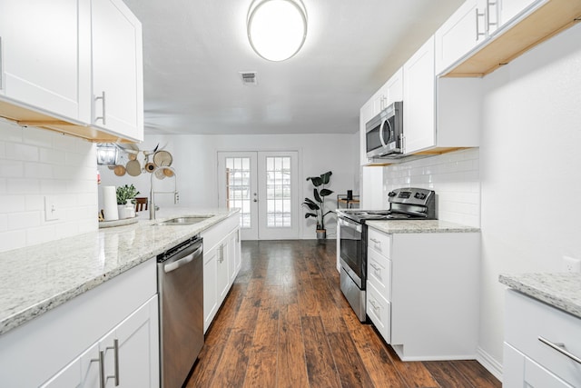 kitchen with sink, backsplash, stainless steel appliances, and dark hardwood / wood-style floors