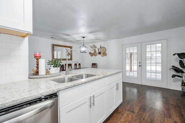 kitchen featuring white cabinets, sink, dishwasher, dark hardwood / wood-style flooring, and hanging light fixtures