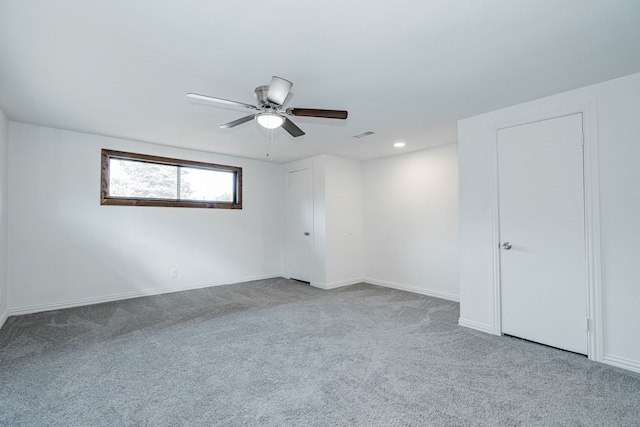 empty room with ceiling fan and carpet flooring