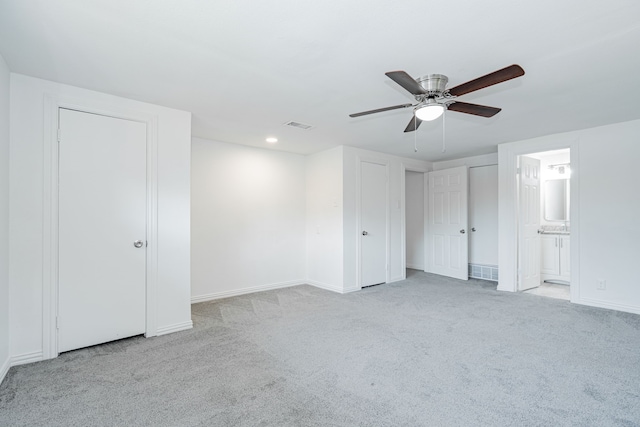 unfurnished bedroom featuring ceiling fan, carpet, and connected bathroom