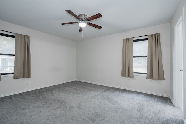 carpeted empty room with plenty of natural light and ceiling fan