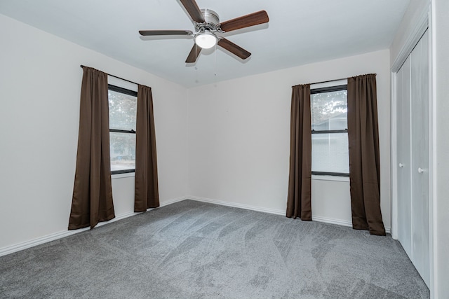 carpeted empty room with ceiling fan