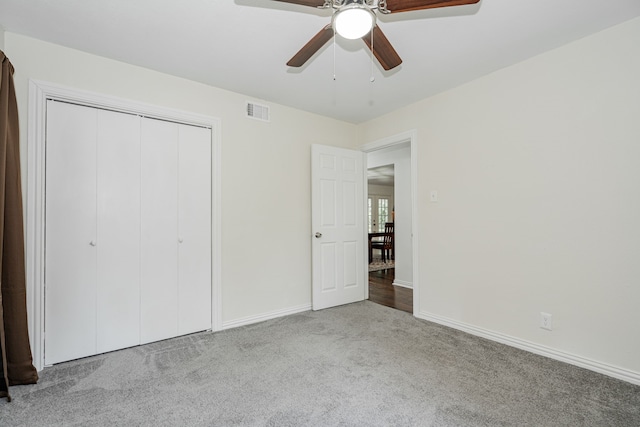 unfurnished bedroom featuring carpet, ceiling fan, and a closet