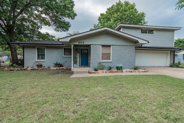 view of front of property with a front lawn and a garage