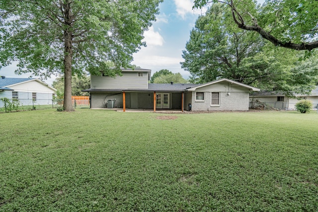 back of house with a lawn