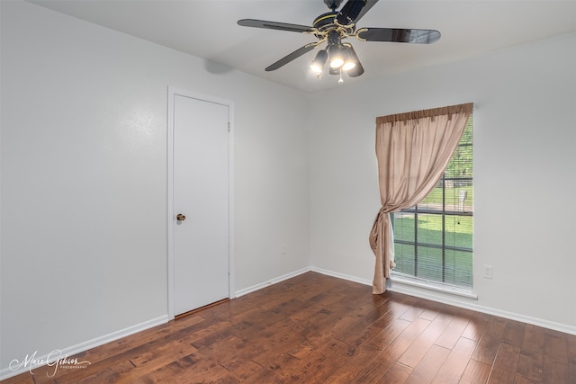 empty room featuring dark wood-type flooring and ceiling fan