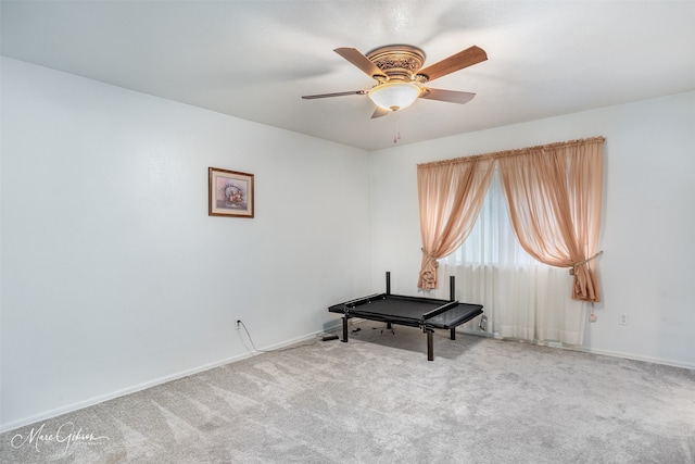 interior space with ceiling fan and carpet floors