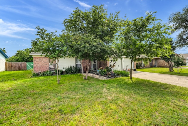 obstructed view of property featuring a garage and a front lawn