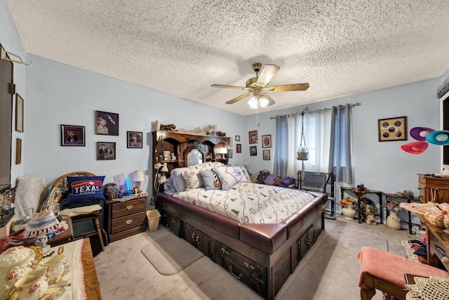 carpeted bedroom featuring ceiling fan and a textured ceiling