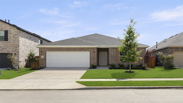 ranch-style house featuring a garage and a front lawn