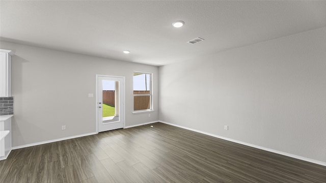 spare room with dark hardwood / wood-style flooring